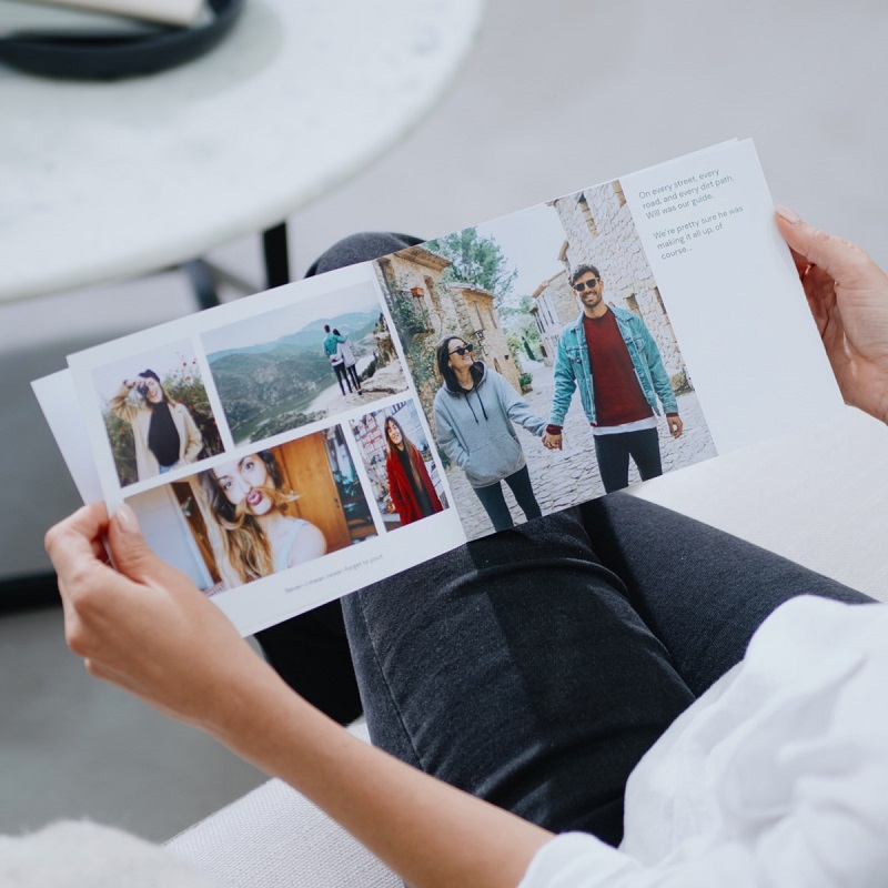 woman watching her photos on the softcover photo book